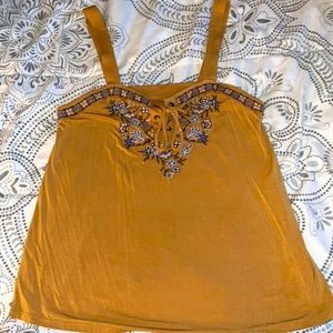 It’s a mustard yellow with flower design on The collar